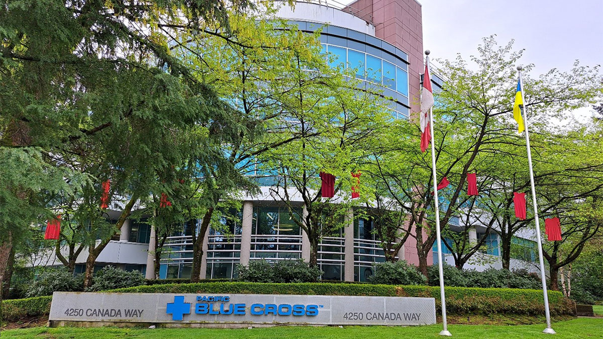 Red Dresses hanging from trees in front of PBC building