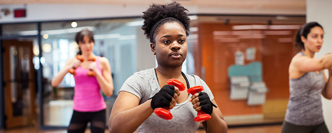 Diverse group of three women taking a resistance training class.