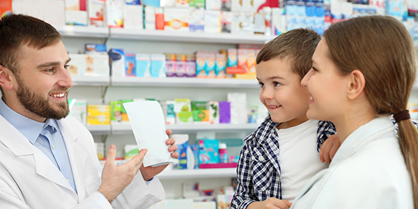 Pharmacist helping mother with child